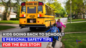 A school bus driving down the street with two children.