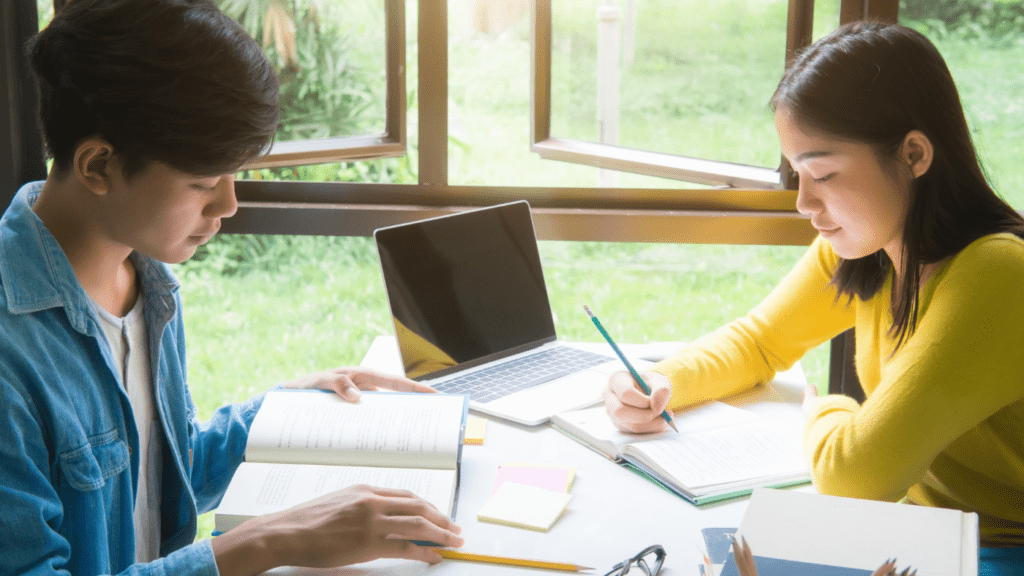 students studying together in their school library equipped with Commercial Fire Alarm System.