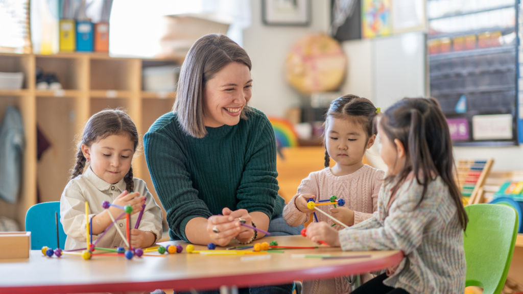 kindergarten students with their teacher in a school equipped with a Commercial Fire Alarm Systems 