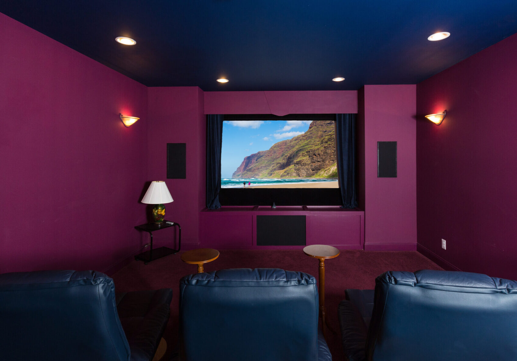 A room with purple walls and blue chairs